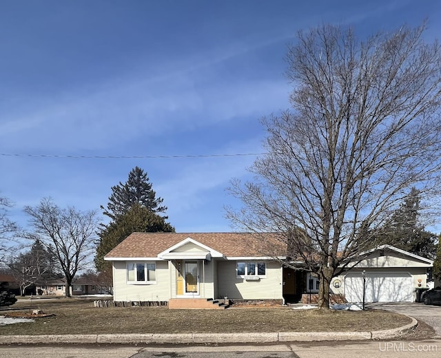 ranch-style house with driveway and a shingled roof