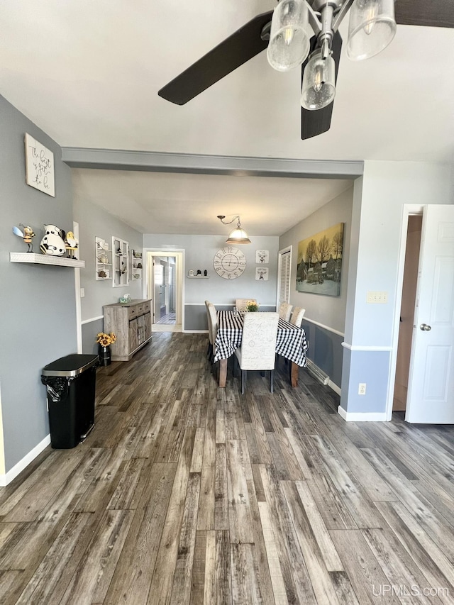 dining space featuring baseboards and wood finished floors