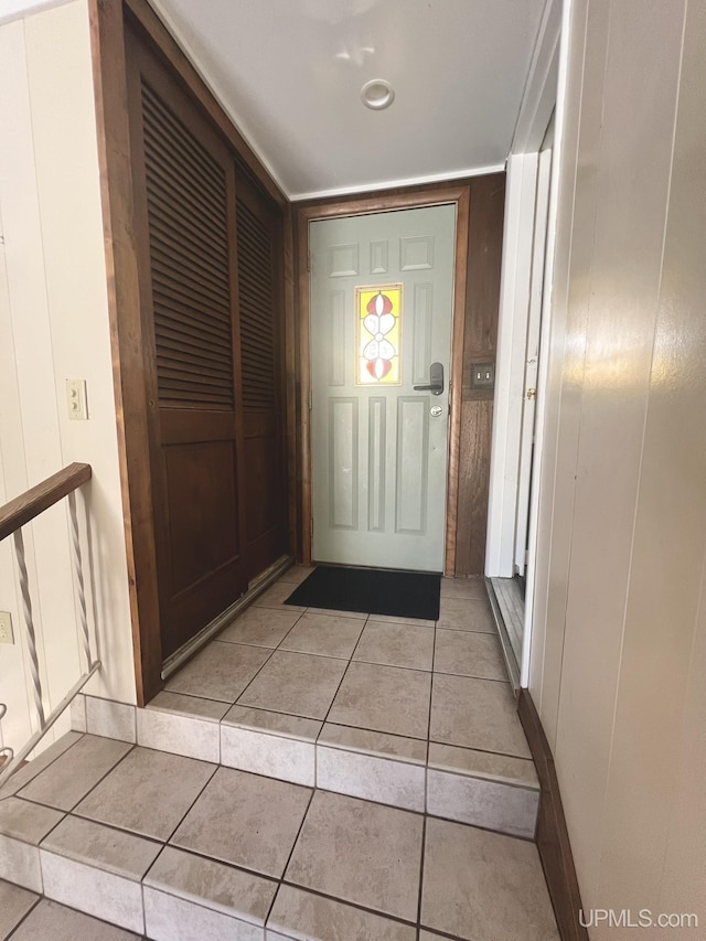 doorway with light tile patterned floors