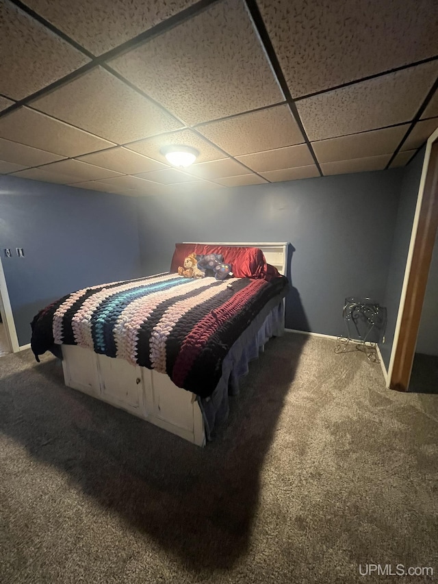 carpeted bedroom featuring a paneled ceiling