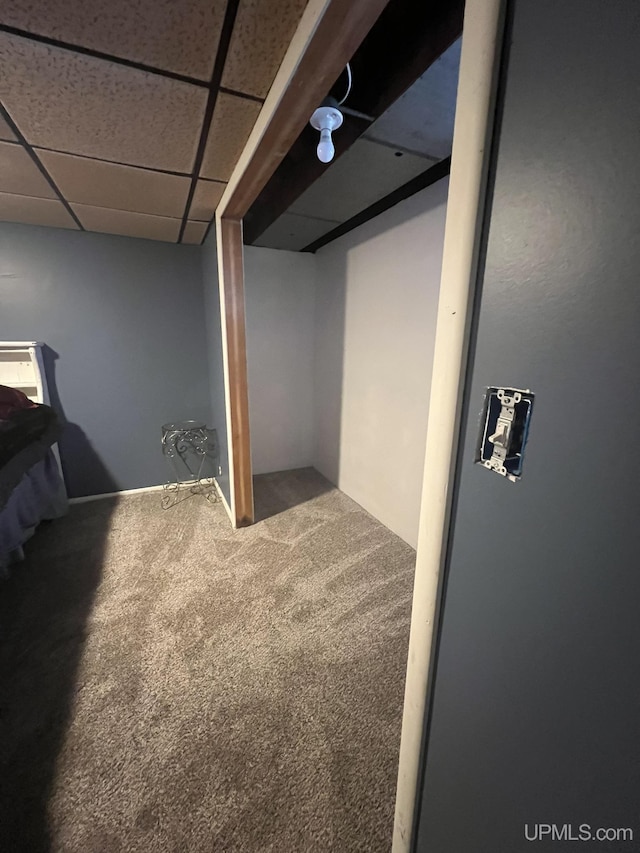 finished basement featuring a drop ceiling and carpet floors