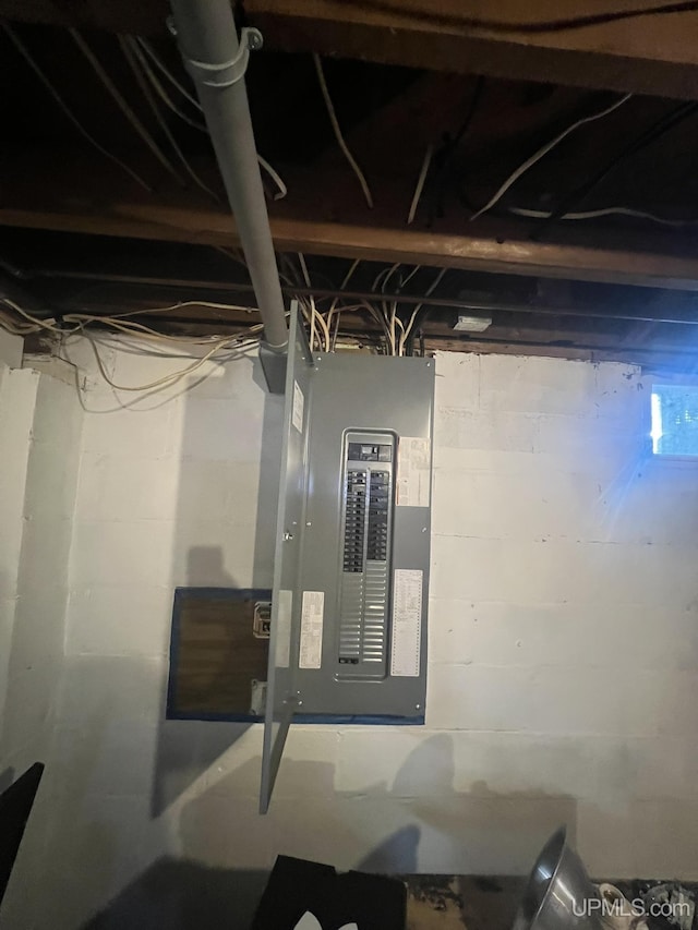 unfinished basement featuring electric panel