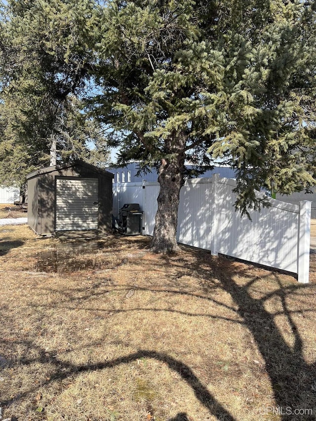 exterior space with a garage, an outdoor structure, and a shed