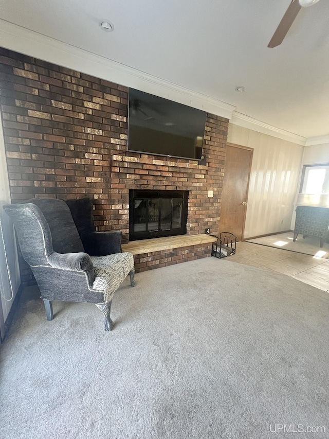 carpeted living room with a fireplace, ceiling fan, and ornamental molding