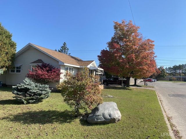 view of side of home with a lawn