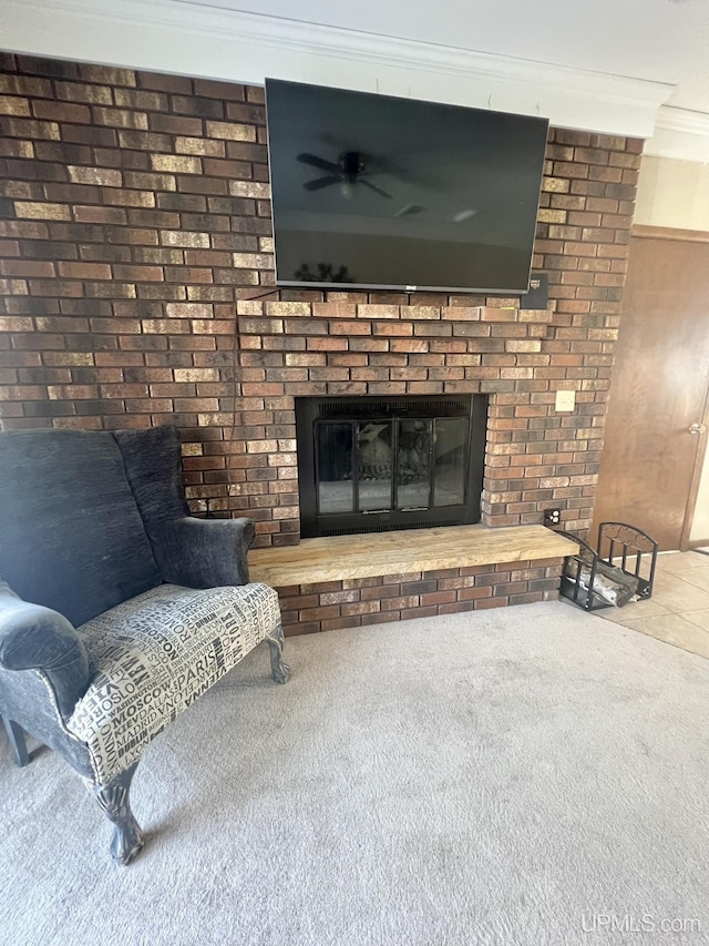 details with carpet flooring, a brick fireplace, a ceiling fan, and ornamental molding