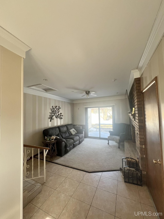 living room featuring a brick fireplace, light tile patterned flooring, a ceiling fan, and ornamental molding