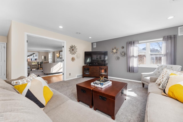 living area with carpet flooring, recessed lighting, baseboards, and visible vents