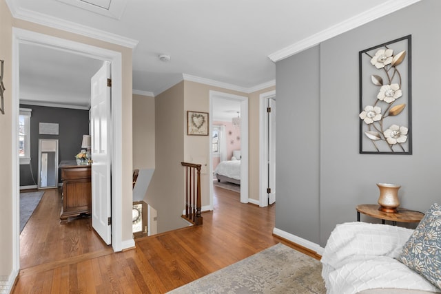 living room featuring baseboards, wood finished floors, and ornamental molding