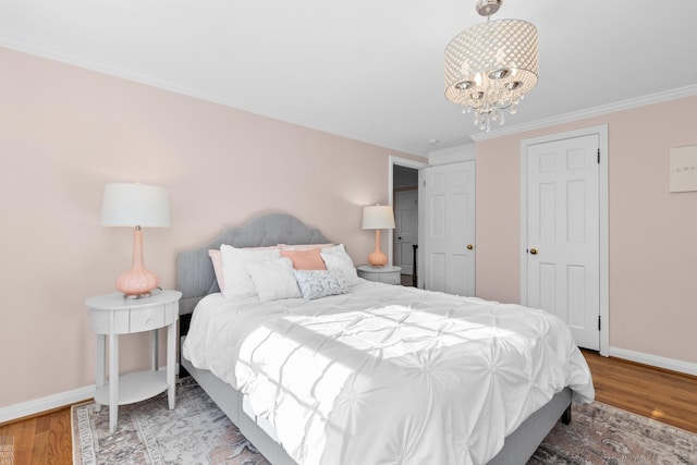 bedroom featuring a chandelier, baseboards, wood finished floors, and crown molding