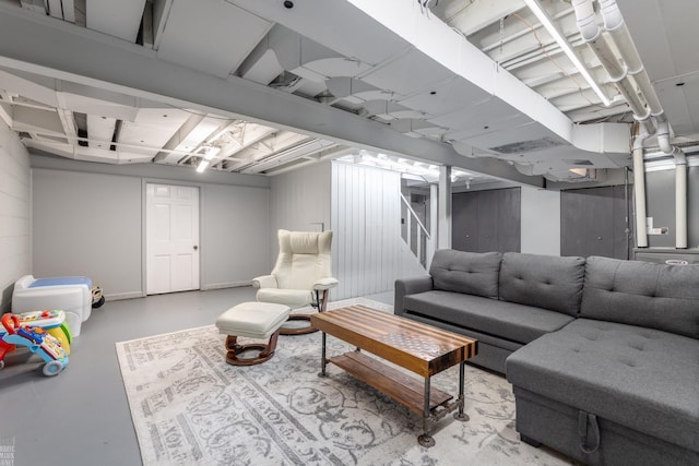 living area with stairway and concrete flooring