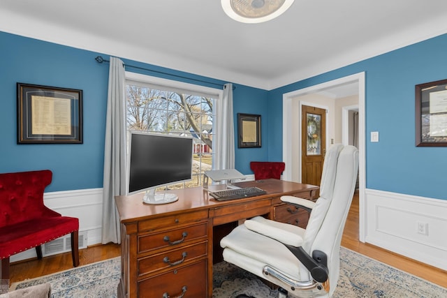 office with visible vents, wainscoting, and wood finished floors