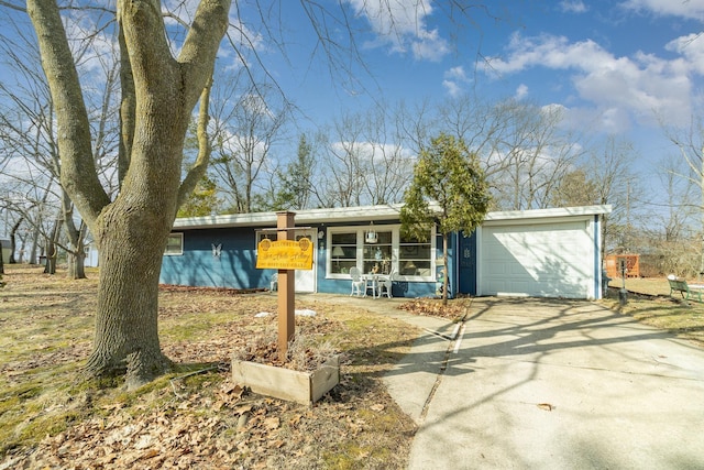 view of front of house with concrete driveway and a garage