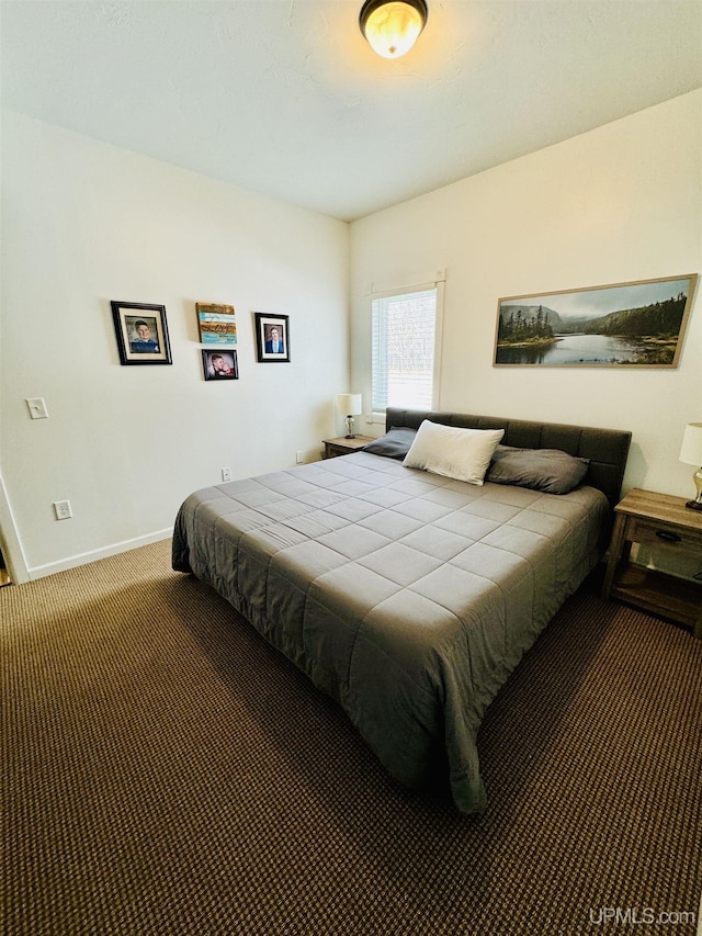 bedroom featuring baseboards and carpet floors