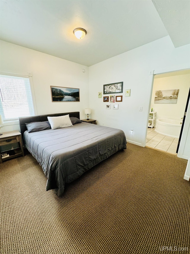 carpeted bedroom with tile patterned floors and baseboards