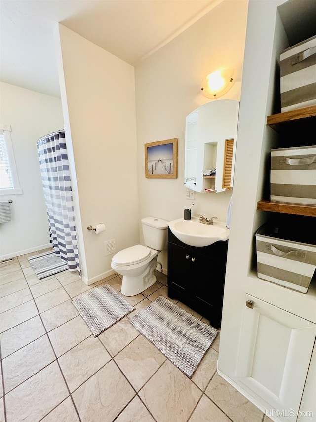 full bath featuring vanity, a shower with shower curtain, baseboards, tile patterned flooring, and toilet