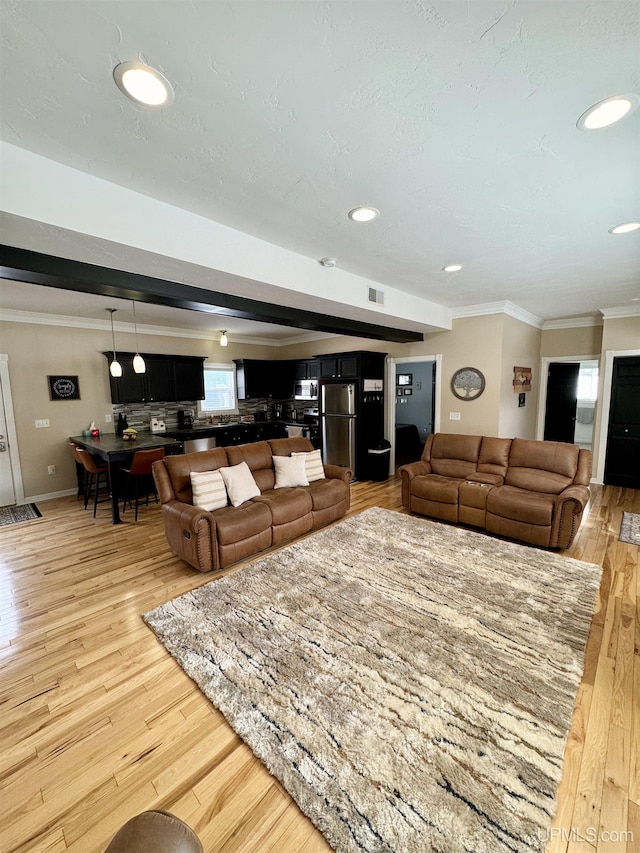 living room featuring recessed lighting, visible vents, light wood-style flooring, and crown molding