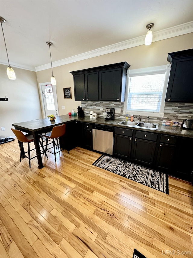 kitchen with light wood-style flooring, a sink, dark countertops, dark cabinetry, and dishwasher