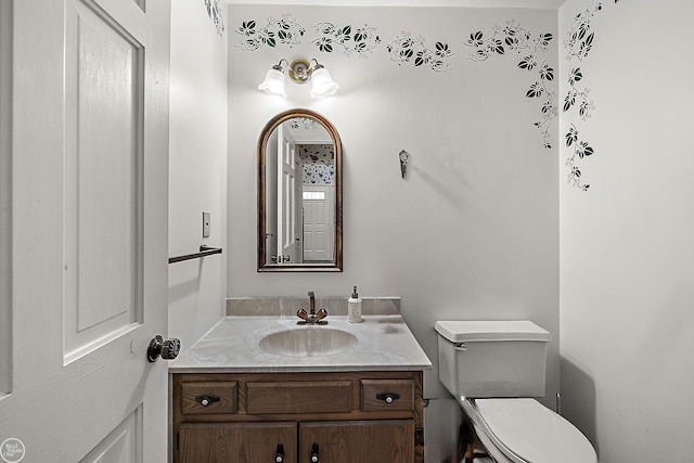 bathroom with toilet and vanity