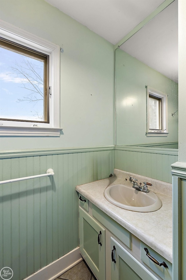 bathroom with a wainscoted wall and vanity