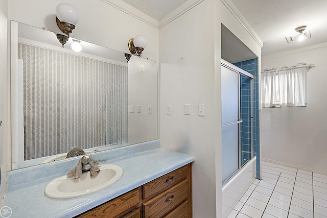 bathroom with visible vents, combined bath / shower with glass door, crown molding, tile patterned flooring, and vanity