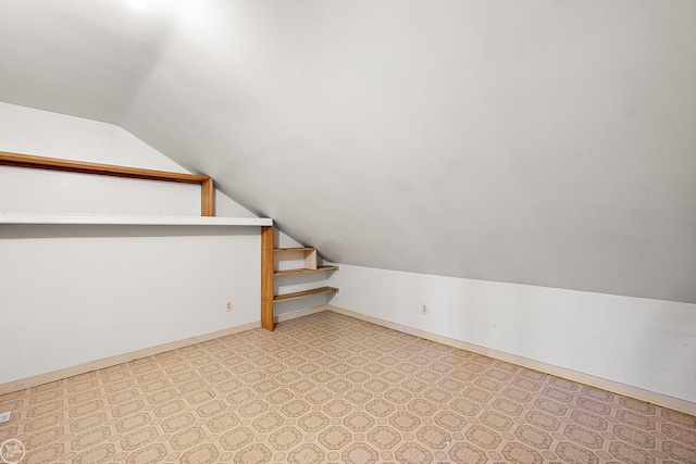 additional living space featuring lofted ceiling and baseboards