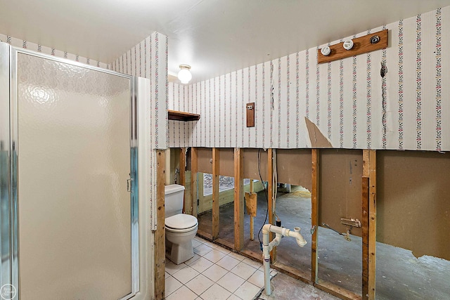 full bathroom with tile patterned floors, toilet, and a stall shower