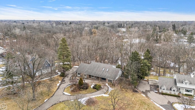 birds eye view of property with a view of trees