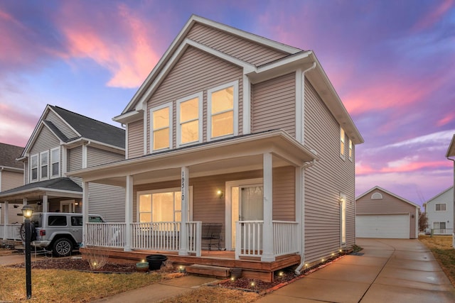 traditional-style home featuring an outbuilding, a porch, and a detached garage