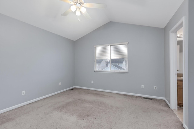 carpeted spare room with baseboards, lofted ceiling, and a ceiling fan