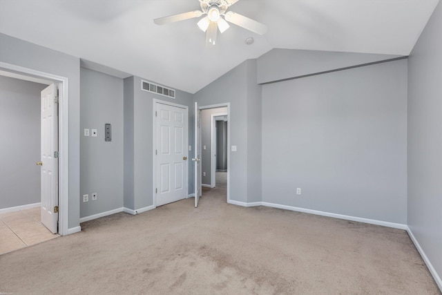 unfurnished bedroom featuring visible vents, baseboards, carpet, and vaulted ceiling