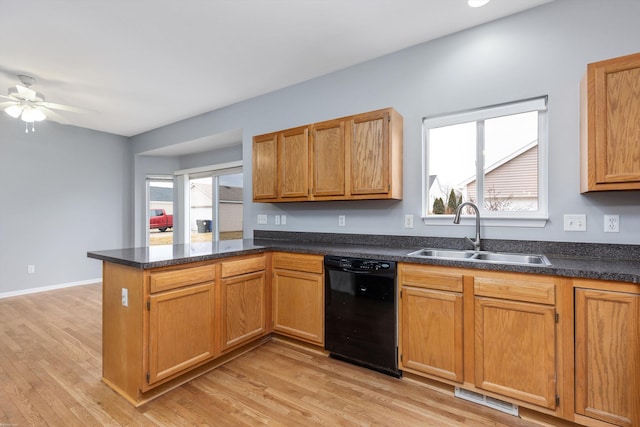 kitchen featuring visible vents, ceiling fan, black dishwasher, a peninsula, and a sink