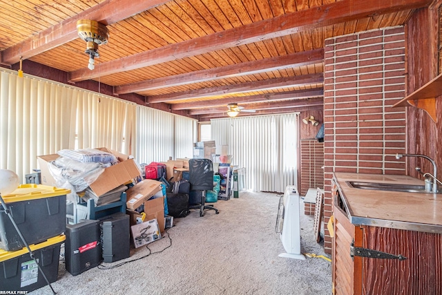 interior space with ceiling fan, wooden ceiling, carpet floors, and a sink