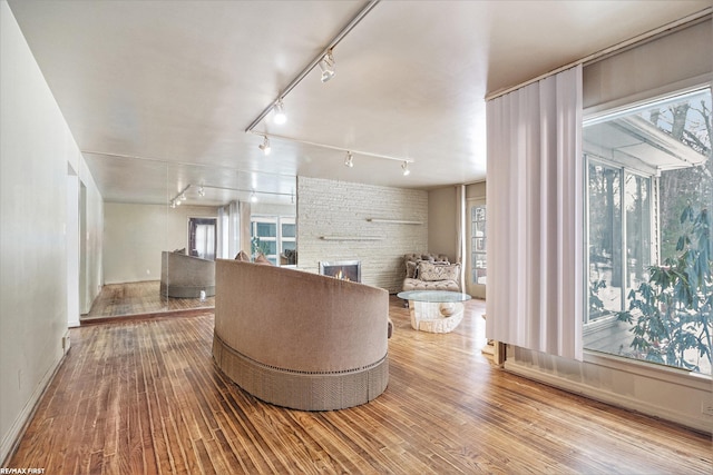 bathroom featuring a large fireplace and wood finished floors