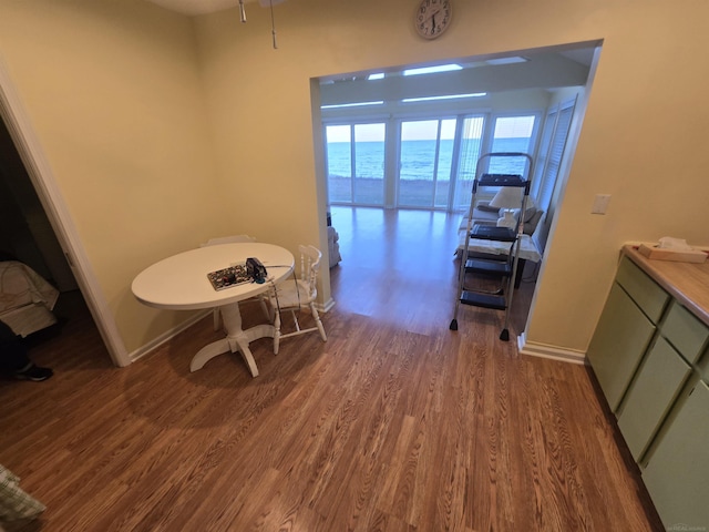 dining area with baseboards and wood finished floors