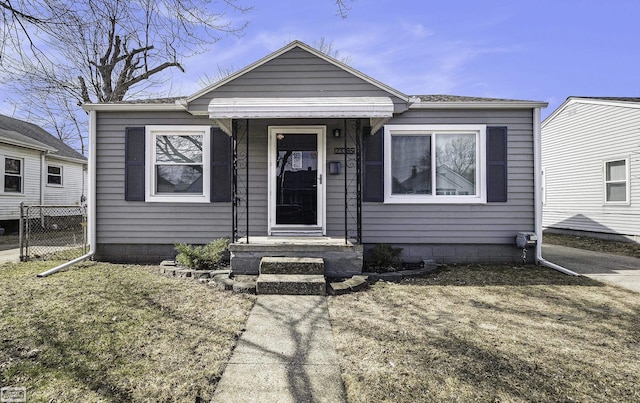 bungalow-style home featuring fence