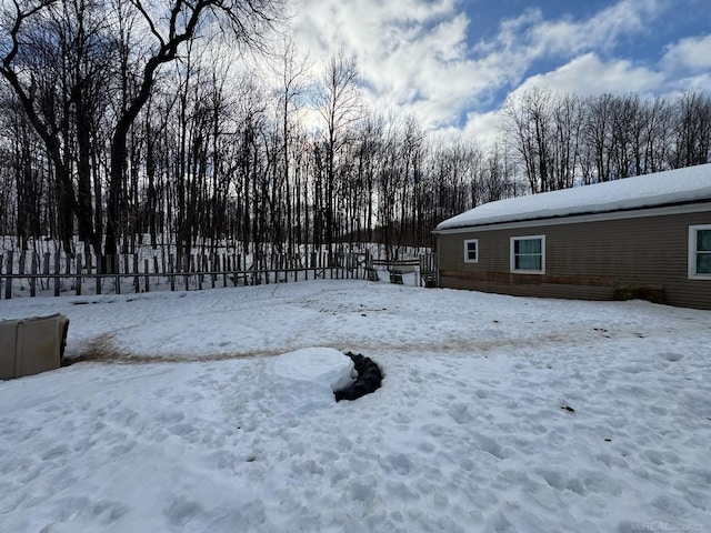 yard covered in snow with a wooden deck