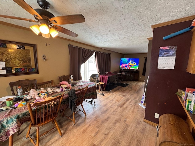 dining room featuring a textured ceiling, a ceiling fan, and light wood-style floors