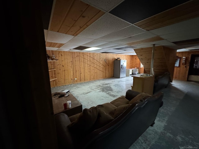 interior space with concrete flooring and wood walls