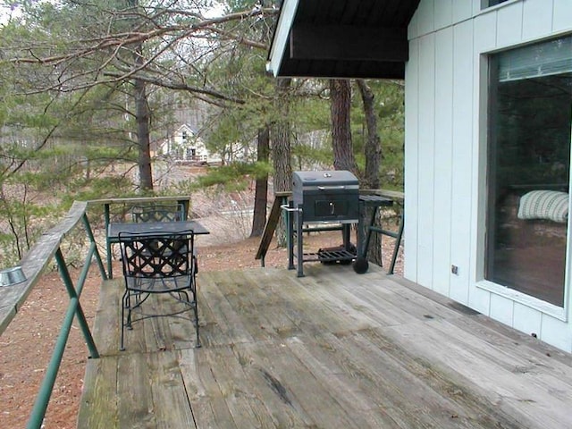 wooden terrace featuring grilling area