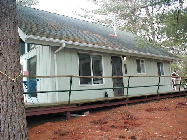 view of property exterior with roof with shingles