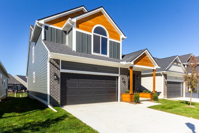 view of front facade featuring brick siding, board and batten siding, concrete driveway, and a front lawn