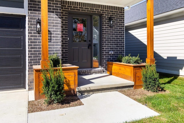 entrance to property with brick siding and covered porch