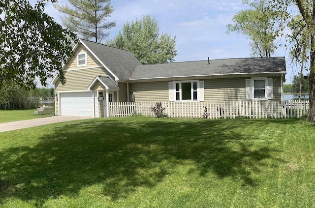 view of front of home featuring concrete driveway, fence, and a front lawn