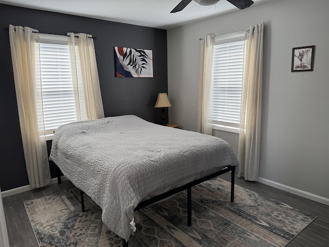 bedroom with ceiling fan, baseboards, and wood finished floors