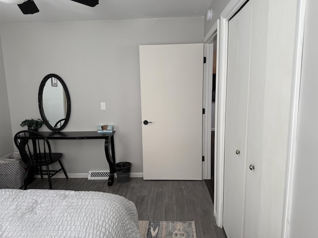 bedroom featuring visible vents, baseboards, wood finished floors, a closet, and a ceiling fan