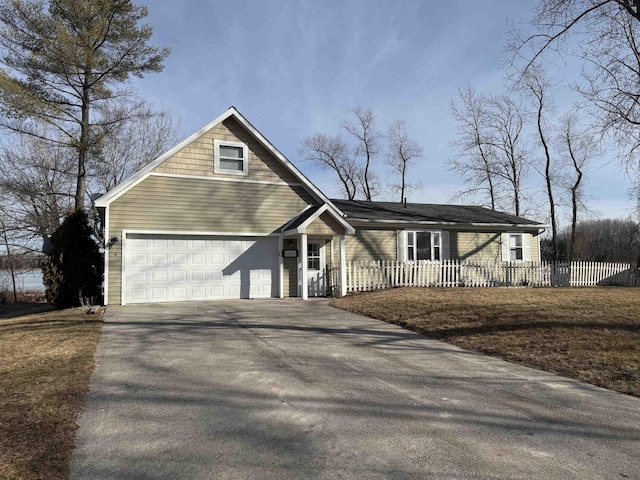 view of front of property featuring driveway and fence