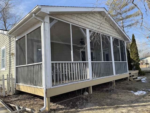 view of property exterior with a sunroom