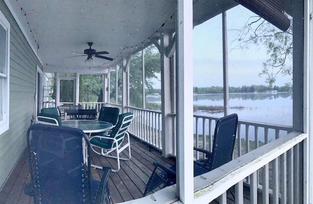 sunroom / solarium featuring a water view and ceiling fan