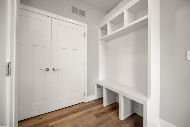 mudroom with wood finished floors and visible vents